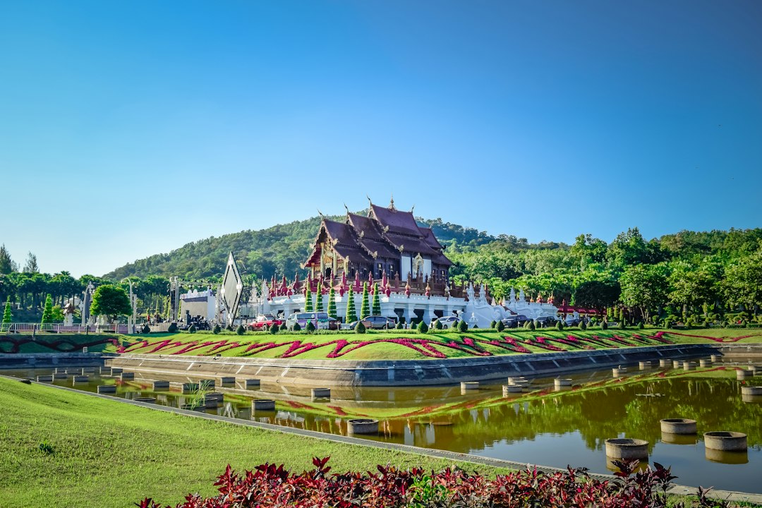 Chiang Mai: a large building sitting on top of a lush green field**