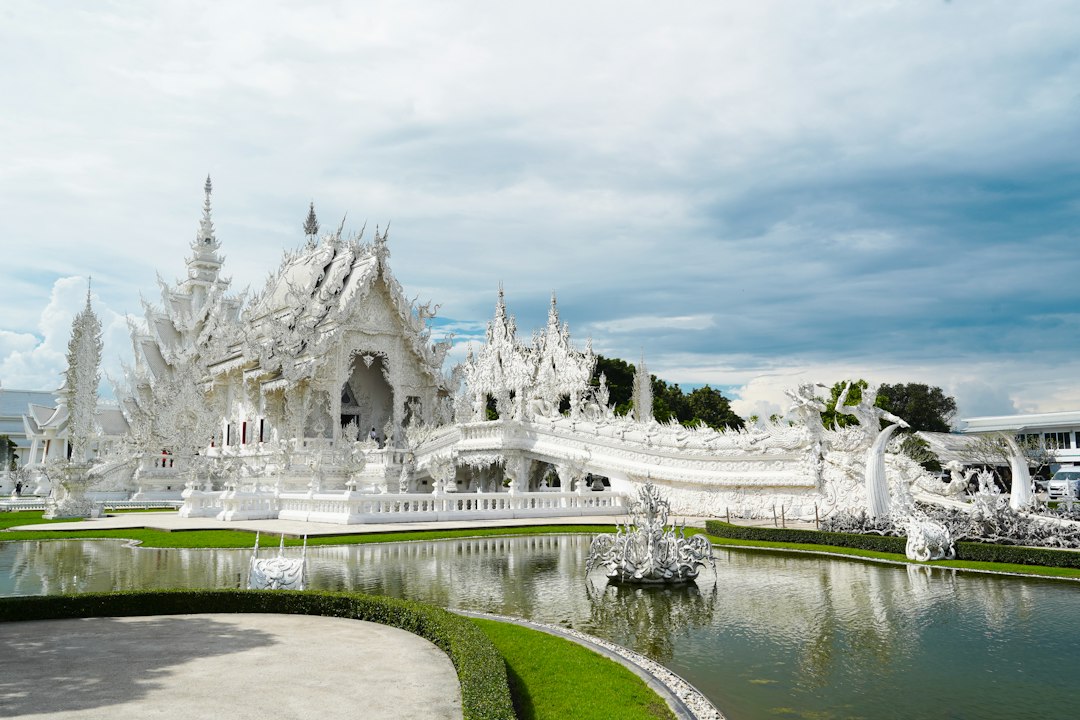 Chiang Rai: a large white building with towers and water in front of it**