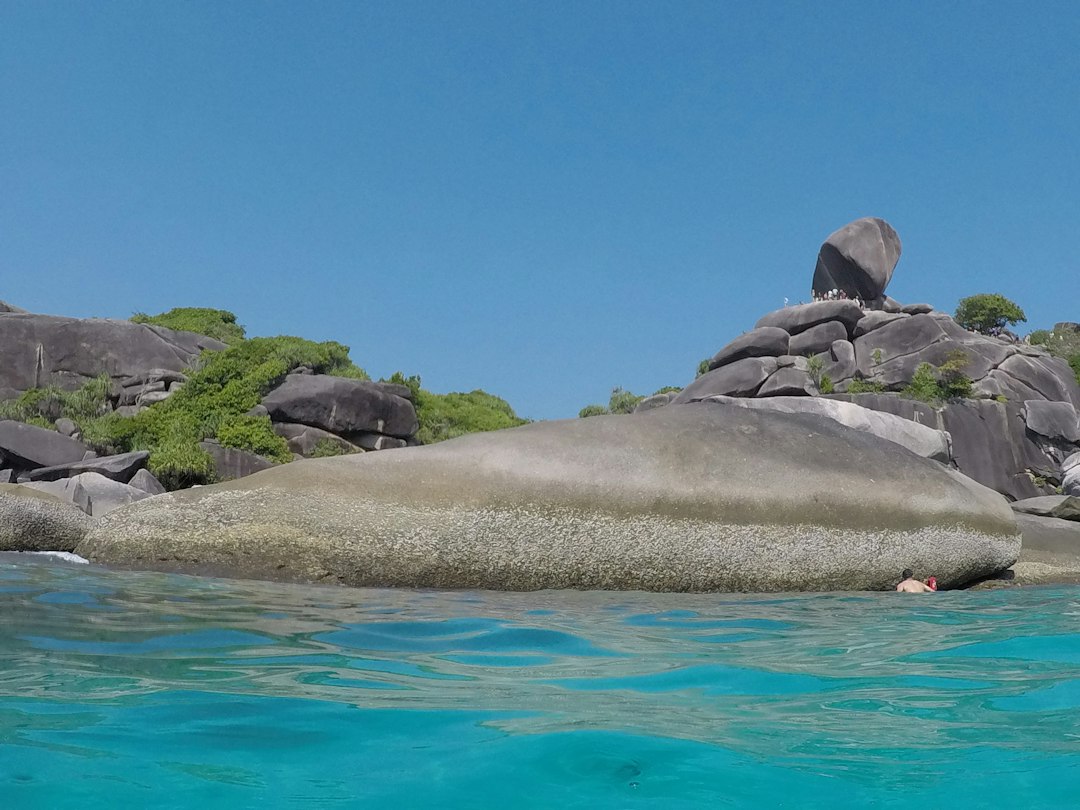 Khao Lak: a group of rocks in the water with Similan Islands in the background**