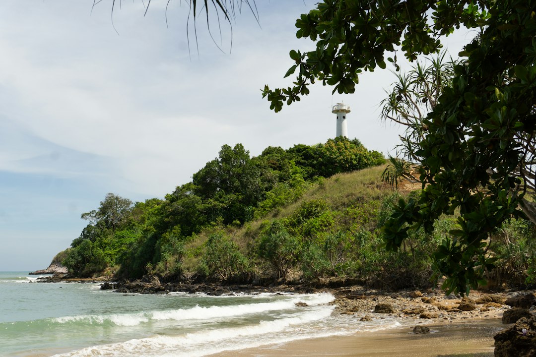 Koh Lanta: A sandy beach with a light house in the distance**